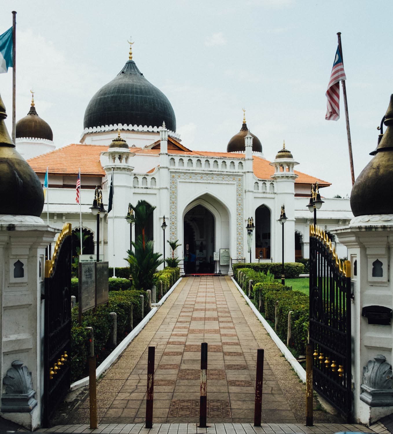 A domed mosque at the end of a tiled path