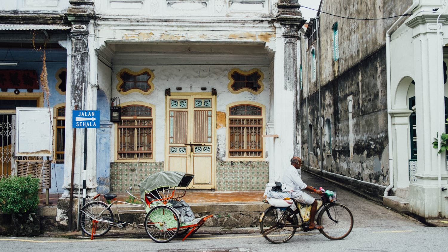 Bicycles outside a weathered George Town shophouse