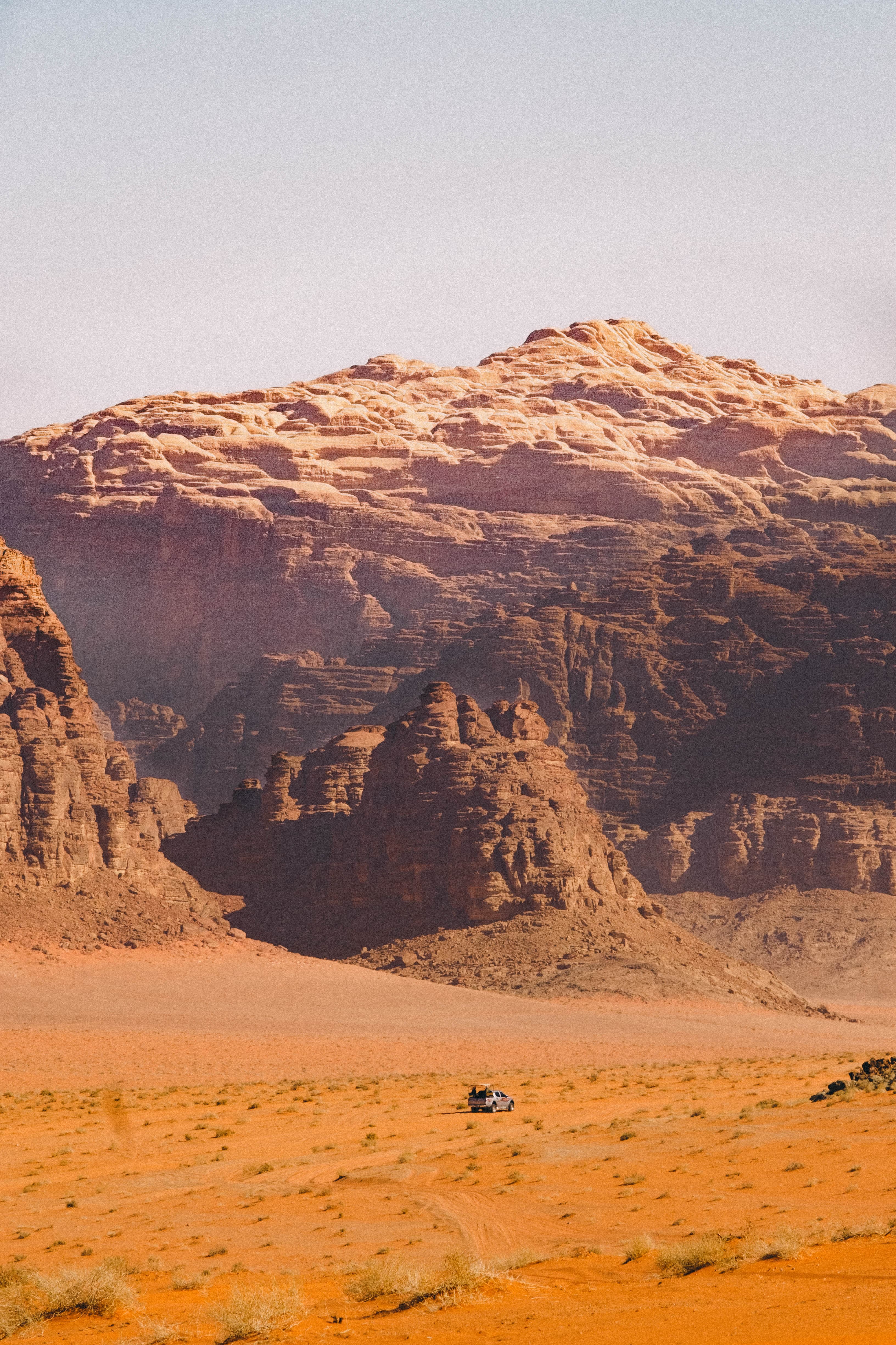 Sunlit sandstone cliffs rising above the desert