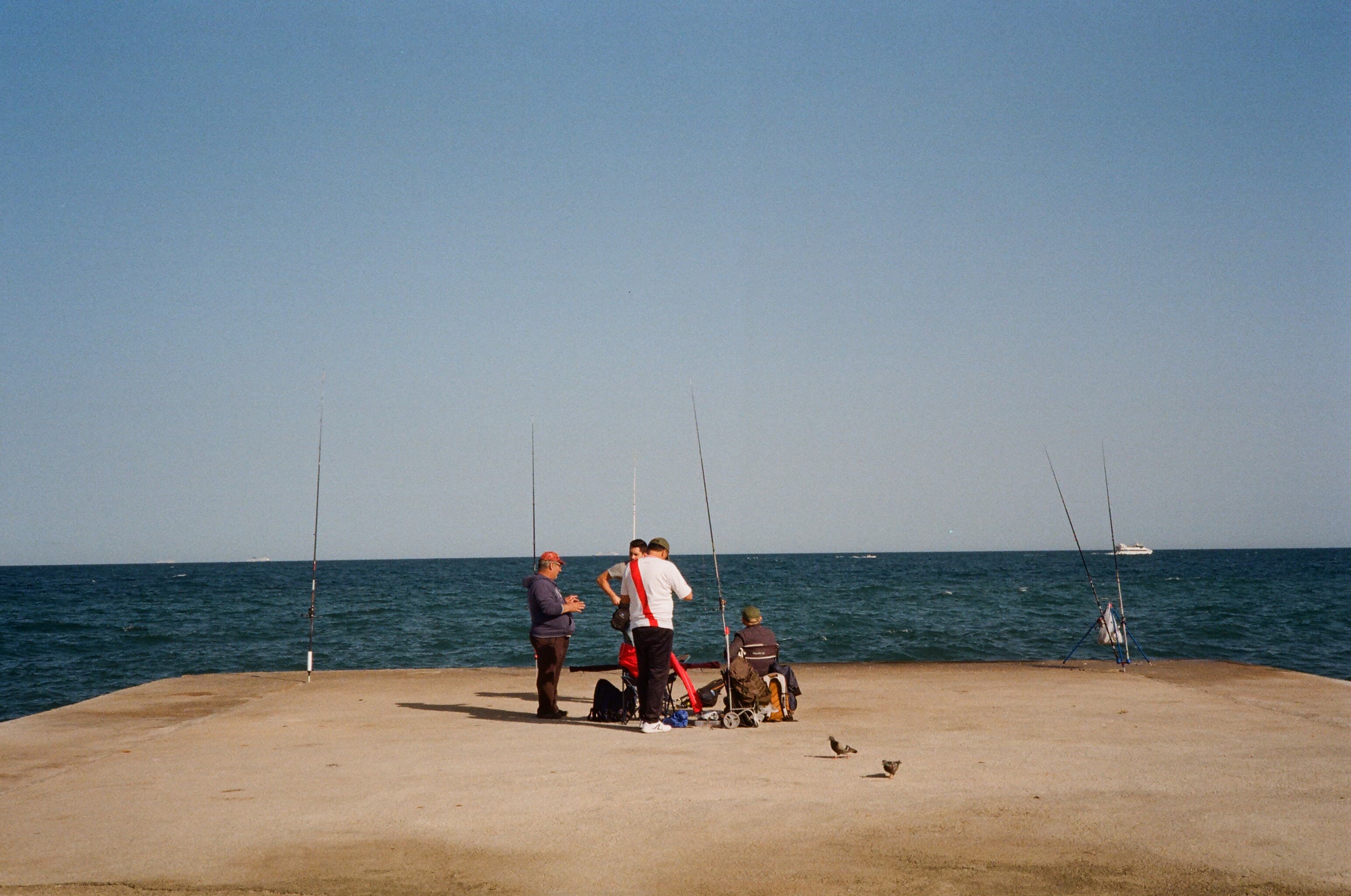 People fishing from a concrete pier