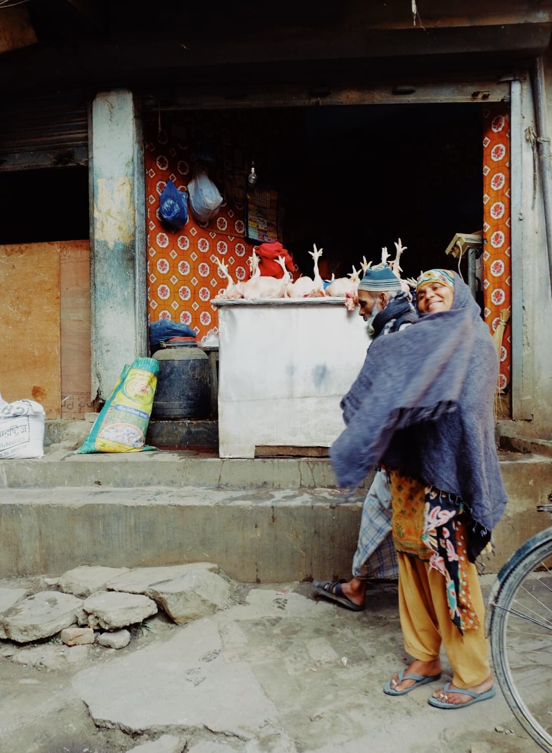 A person standing outside a small roadside shop