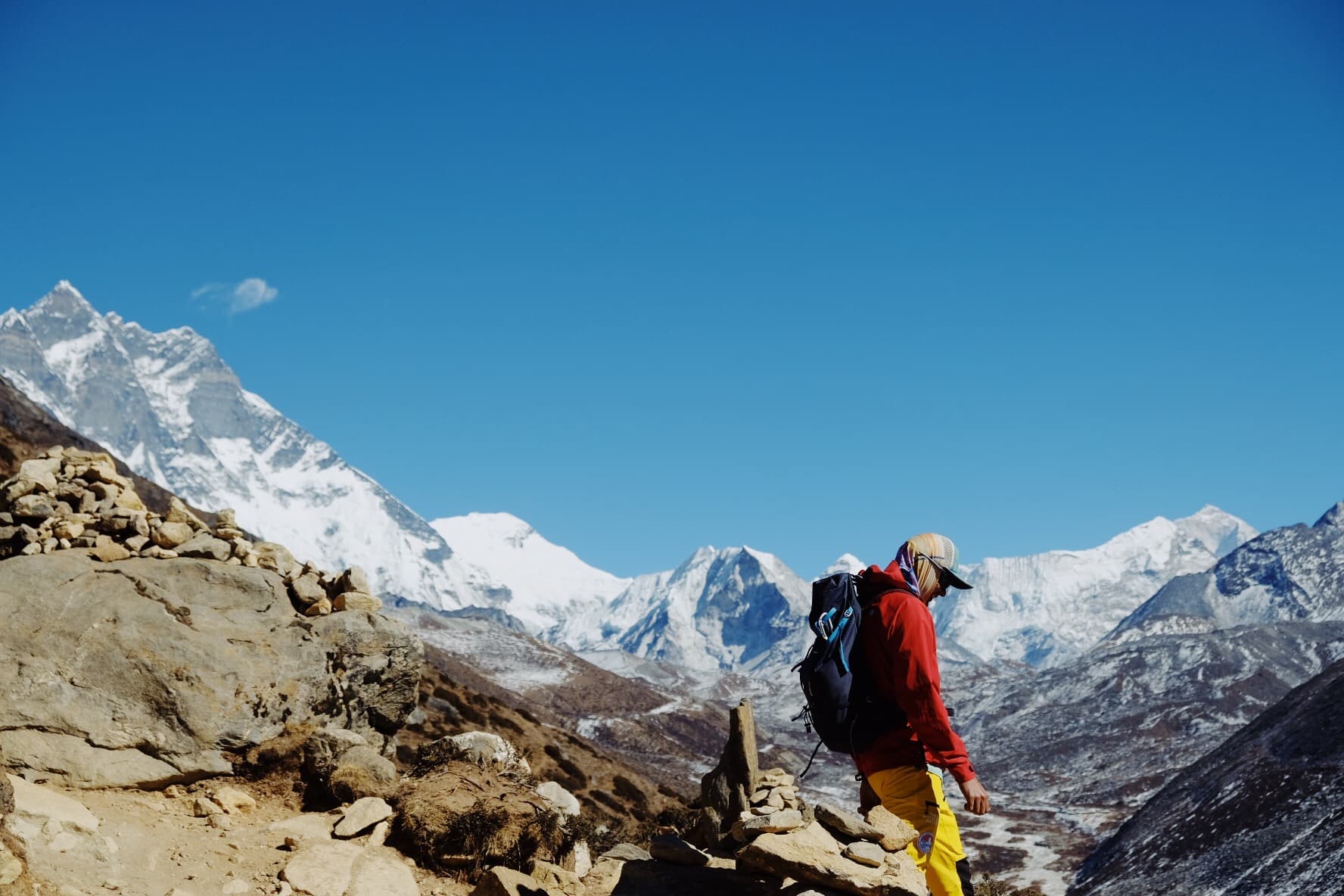 Trekkers crossing a rocky Himalayan landscape