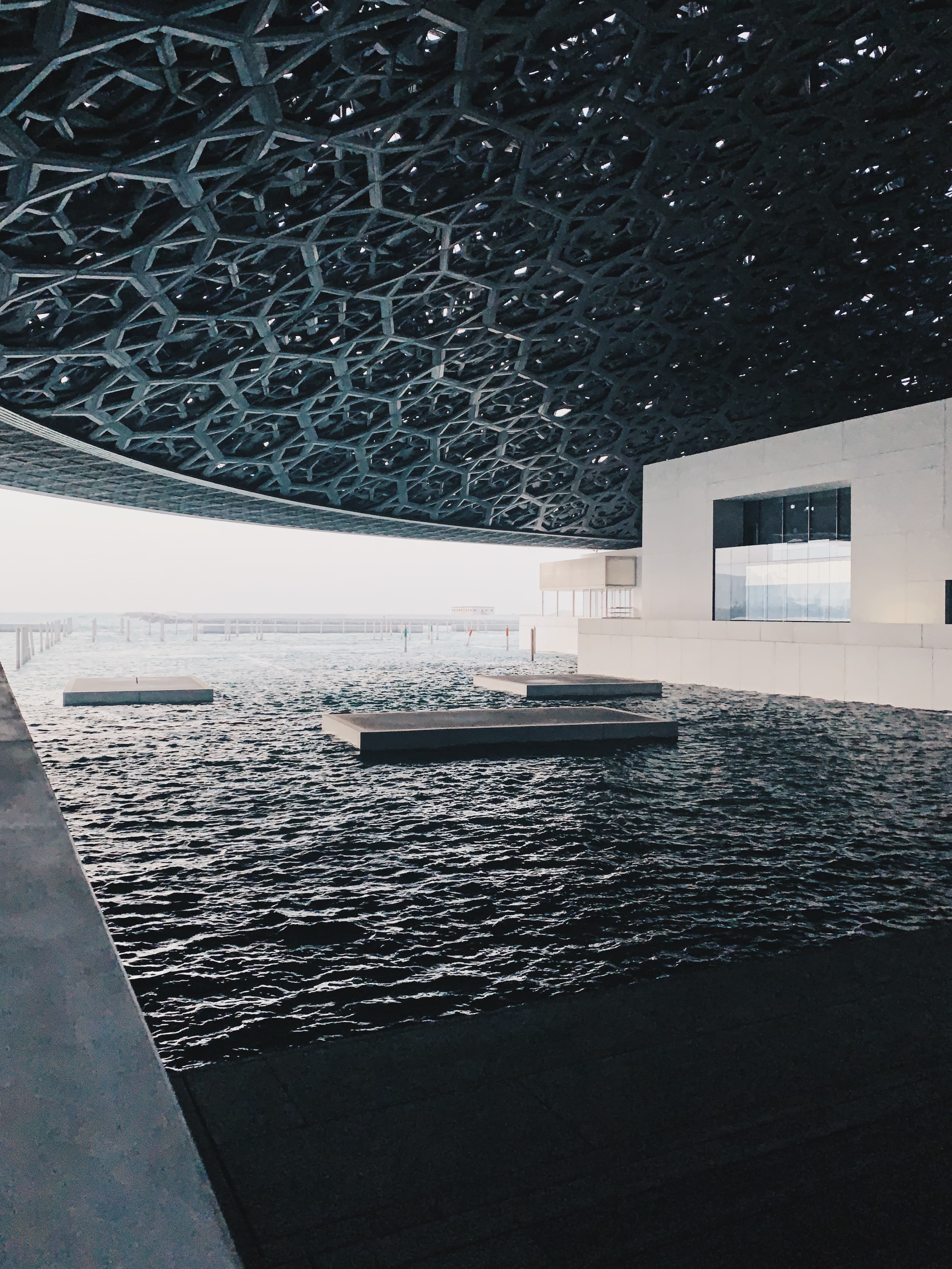 A pool beneath a geometric patterned ceiling