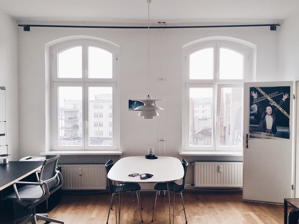 A bright studio meeting room with arched windows