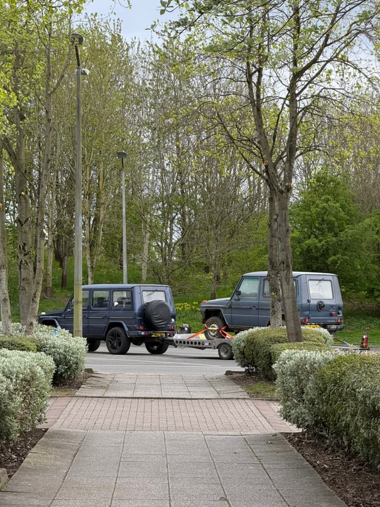 A four-wheel drive vehicle parked beneath trees