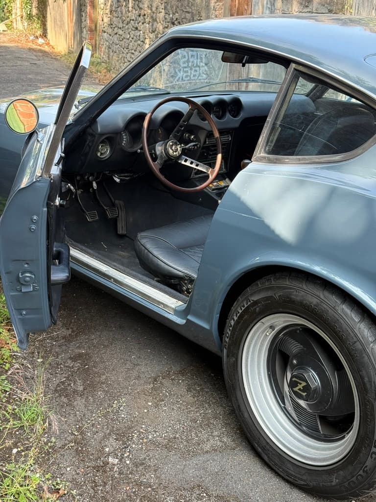 The open door and interior of a classic car