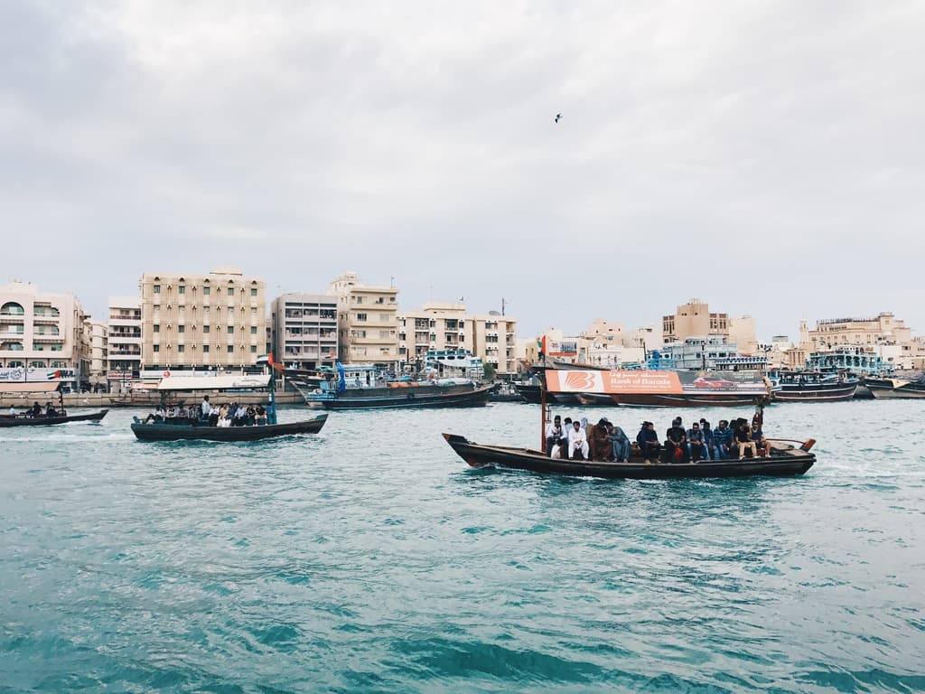 Passenger boats crossing the water by the city