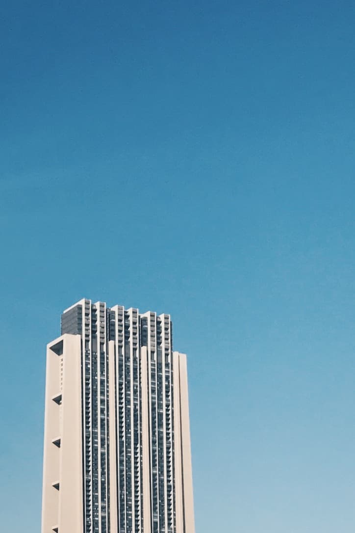 A concrete tower rising into a clear blue sky